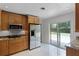 Modern kitchen with granite counters, stainless steel appliances, and a view of the pool at 2311 Huron Trl, Maitland, FL 32751