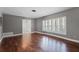 An elegant living room boasting hardwood floors and large windows that fill the space with natural light at 2311 Huron Trl, Maitland, FL 32751