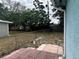 A spacious backyard area, featuring a partial patio and chain-link fence, offering potential for landscaping at 2322 Vincent Rd, Orlando, FL 32817