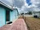 View of the backyard featuring a tiled patio and chain-link fence, with neighboring houses visible at 2322 Vincent Rd, Orlando, FL 32817