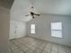 Inviting bedroom with neutral walls, tile flooring, and a ceiling fan at 2322 Vincent Rd, Orlando, FL 32817