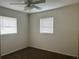 Bedroom featuring dual windows and a ceiling fan for a comfortable and bright space at 2322 Vincent Rd, Orlando, FL 32817