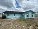 Back exterior view of the house shows the siding, and ample outdoor space perfect for customizing at 2322 Vincent Rd, Orlando, FL 32817