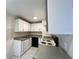 Bright kitchen featuring white cabinets, dark appliances, and light countertops at 2322 Vincent Rd, Orlando, FL 32817