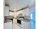 Functional kitchen equipped with white cabinetry and modern appliances at 2322 Vincent Rd, Orlando, FL 32817