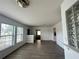 Well-lit living room with wood-look flooring and an open layout to other rooms at 2322 Vincent Rd, Orlando, FL 32817