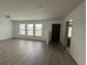 Bright living room featuring wood-look flooring and multiple windows for natural light at 2322 Vincent Rd, Orlando, FL 32817