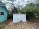 Features a white storage shed in the backyard, providing extra storage for tools and equipment at 2322 Vincent Rd, Orlando, FL 32817