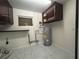 Utility room featuring cabinets, hot water heater and storage at 2322 Vincent Rd, Orlando, FL 32817