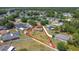 Aerial view of a home showcasing a large lot with ample space and mature trees in a quiet neighborhood at 241 Churchill Ct, Kissimmee, FL 34758