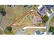 Aerial view of a property with a spacious lot, mature trees and long driveway at 241 Churchill Ct, Kissimmee, FL 34758