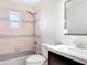 Clean bathroom with a shower-tub combo, classic tile, and a bright vanity at 241 Churchill Ct, Kissimmee, FL 34758