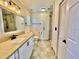 Bathroom featuring a new shower, granite countertops, and shaker cabinets at 241 Churchill Ct, Kissimmee, FL 34758