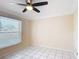 Clean, neutral bedroom with large window and tiled floor offers simplicity and comfort at 241 Churchill Ct, Kissimmee, FL 34758