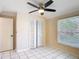 Bright bedroom featuring a ceiling fan, closet, and large window for natural light at 241 Churchill Ct, Kissimmee, FL 34758