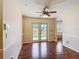 Dining area with wood floors and a view to the back yard through French doors at 241 Churchill Ct, Kissimmee, FL 34758