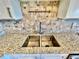 Kitchen sink featuring a stainless-steel sink, modern faucet, and light granite countertops at 241 Churchill Ct, Kissimmee, FL 34758