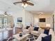 Spacious living room with hardwood floors, modern decor, and abundant natural light at 241 Churchill Ct, Kissimmee, FL 34758