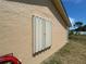 Closed accordion style hurricane shutter on the exterior of the home at 241 Churchill Ct, Kissimmee, FL 34758