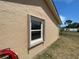 Opened accordion style hurricane shutter on the exterior of the home at 241 Churchill Ct, Kissimmee, FL 34758