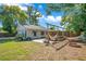 Backyard featuring a hammock, fire pit, patio, and mature trees for shade at 2812 E Michigan St, Orlando, FL 32806