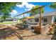 Backyard features a covered patio with outdoor seating, string lights, and manicured landscaping at 2812 E Michigan St, Orlando, FL 32806