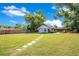 Aerial view of a backyard with a large lawn, patio, hammock, and detached garage at 2812 E Michigan St, Orlando, FL 32806