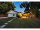 Cozy backyard features a patio with string lights, a hammock, and a well-maintained lawn at 2812 E Michigan St, Orlando, FL 32806