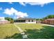 Spacious backyard featuring lush grass, stepping stones and a screened in back porch at 2812 E Michigan St, Orlando, FL 32806