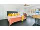 Bright bedroom with hardwood floors, a ceiling fan, and many bright windows at 2812 E Michigan St, Orlando, FL 32806
