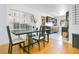 Modern dining room with hardwood floors, large table, and decorative glass block window for added privacy at 2812 E Michigan St, Orlando, FL 32806