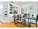 Modern dining room with hardwood floors, large table, and decorative glass block window for added privacy at 2812 E Michigan St, Orlando, FL 32806