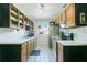 Well-lit kitchen featuring white countertops, oak cabinets, and black appliances at 2812 E Michigan St, Orlando, FL 32806