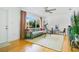 Bright living room with hardwood floors, large window with backyard views, and comfortable modern furnishings at 2812 E Michigan St, Orlando, FL 32806