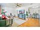 Bright living room with hardwood floors, large window with backyard views, and comfortable modern furnishings at 2812 E Michigan St, Orlando, FL 32806