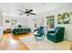 Spacious main bedroom with hardwood floors, ceiling fan, sitting area, and three large windows at 2812 E Michigan St, Orlando, FL 32806