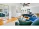 Spacious main bedroom with hardwood floors, ceiling fan, sitting area, and three large windows at 2812 E Michigan St, Orlando, FL 32806