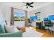 Office with large windows, wood floors, and a seating area for work or relaxation at 2812 E Michigan St, Orlando, FL 32806