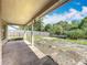 Large, partially fenced backyard, with mature trees, with covered patio and trampoline at 2850 Tremont Dr, Eustis, FL 32726