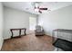 Neutral bedroom with a ceiling fan, table, chair and cage at 2850 Tremont Dr, Eustis, FL 32726