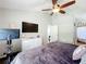 Vaulted primary bedroom with ceiling fan, television, and Peloton exercise bike at 2850 Tremont Dr, Eustis, FL 32726