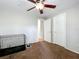 Neutral bedroom with a ceiling fan, cage and two doors at 2850 Tremont Dr, Eustis, FL 32726