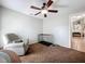 Neutral bedroom with a ceiling fan, chair and a cage at 2850 Tremont Dr, Eustis, FL 32726