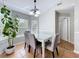 Bright dining area with large windows, modern chandelier, and tile flooring at 2850 Tremont Dr, Eustis, FL 32726
