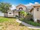 Inviting home exterior with a neatly maintained lawn and manicured bushes along the front entryway at 2850 Tremont Dr, Eustis, FL 32726