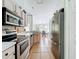 Efficient kitchen layout with stainless steel appliances, tile flooring, and modern fixtures at 2850 Tremont Dr, Eustis, FL 32726