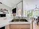 The kitchen sink overlooks a dining area and living room with fireplace at 2850 Tremont Dr, Eustis, FL 32726