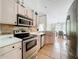 Well lit kitchen featuring stainless steel appliances and tiled flooring and backsplash at 2850 Tremont Dr, Eustis, FL 32726