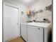 Convenient laundry room with modern side-by-side washer and dryer, plus storage shelf at 2850 Tremont Dr, Eustis, FL 32726