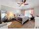 Main bedroom featuring a ceiling fan, curtains and exercise bike at 2850 Tremont Dr, Eustis, FL 32726